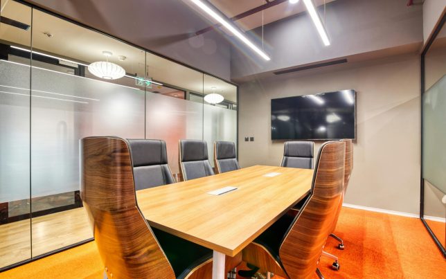 Sophisticated conference room with sleek furniture and glass walls. Ideal for business meetings.